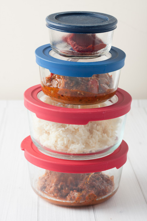 isolated close up of stack of glass containers with leftovers